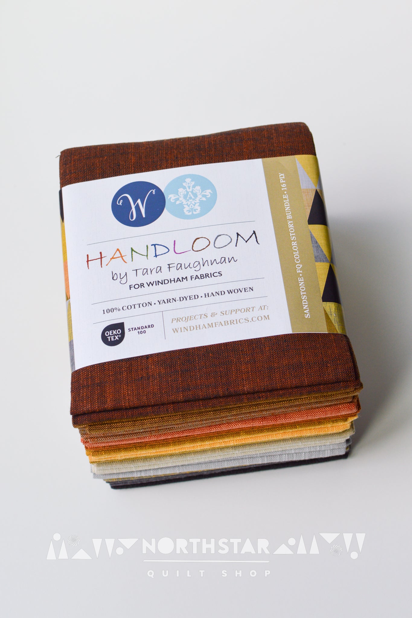 Folded Sandstone yarn-dyed woven fat quarter bundle in brown, gray, and black tones.