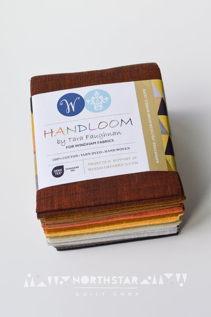 Folded Sandstone yarn-dyed woven fat quarter bundle in brown, gray, and black tones.