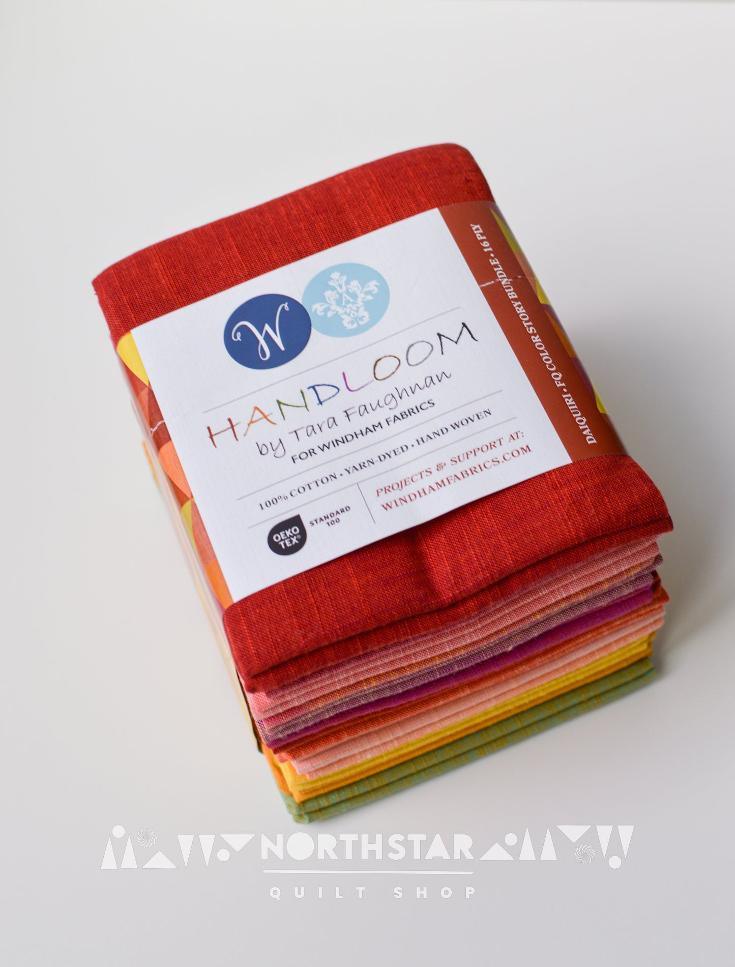 Folded Daiquiri yarn-dyed woven fat quarter bundle for quilting projects.
