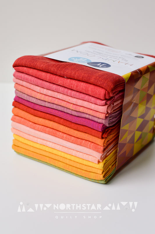 Daiquiri Handloom fat quarter bundle by Tara Faughnan featuring red, orange, and yellow woven fabrics.