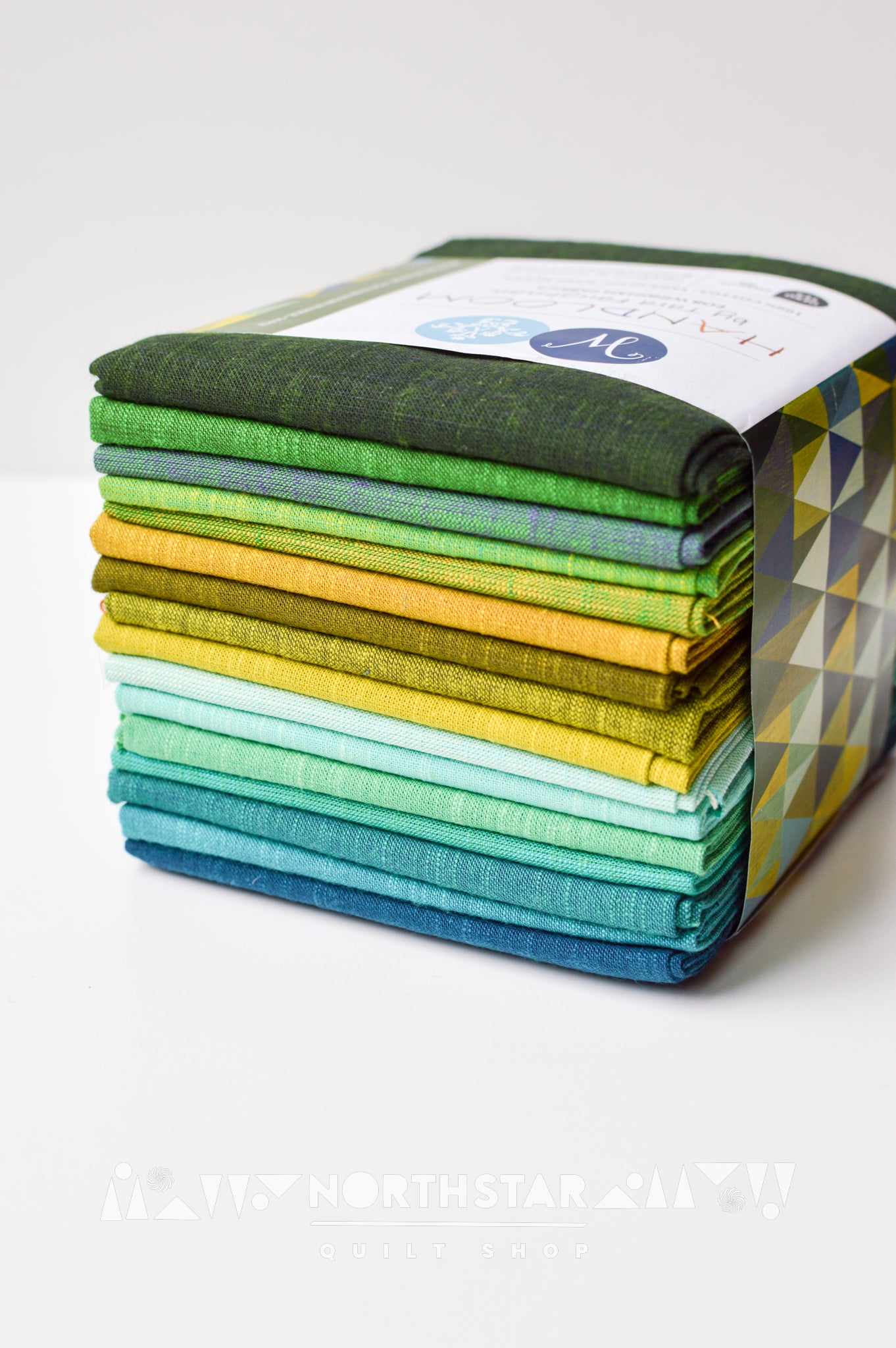 Mountain Meadow Handloom fat quarter bundle by Tara Faughnan featuring 16 green, teal, and yellow woven fabrics.