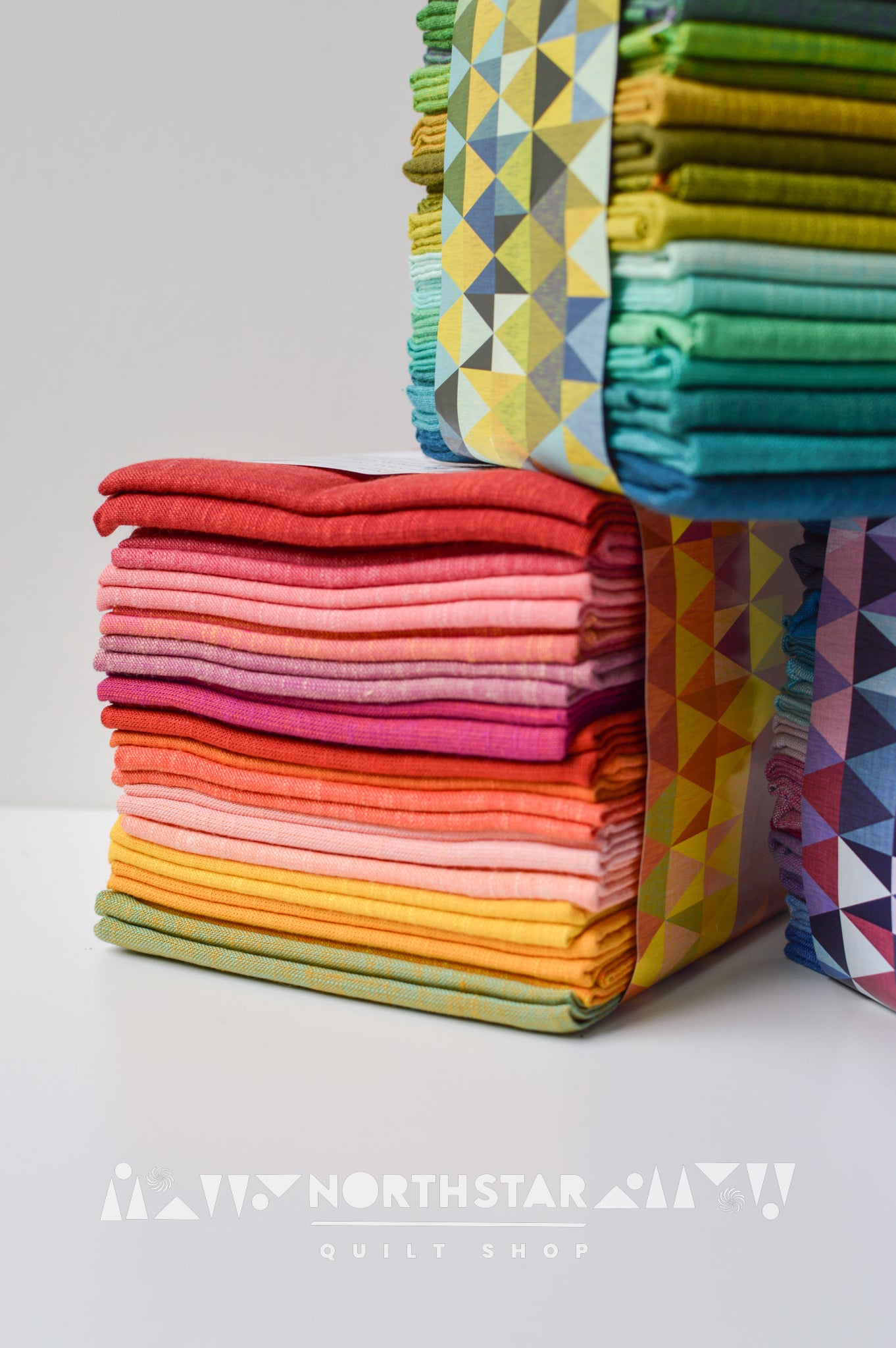 Bright modern quilting fabric bundle in warm colors by Tara Faughnan.