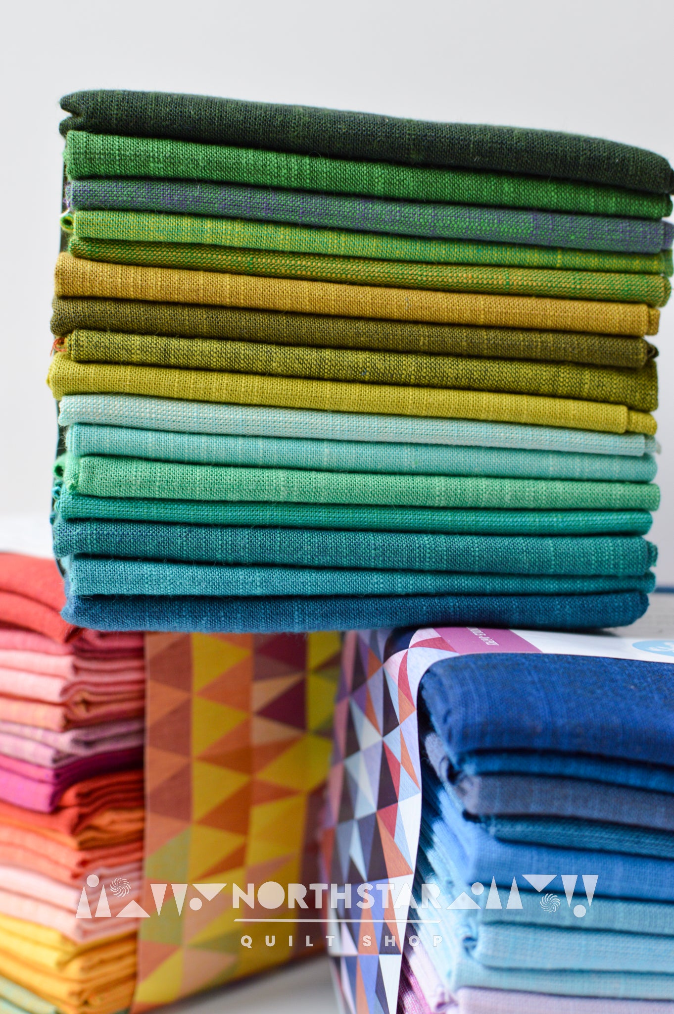 Modern quilting fabric bundle in green, teal, and yellow by Tara Faughnan.